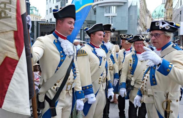 German historical military enthusiasts dressed in Deutschmaster Spielmannnszug uniforms from Bad Mergentheim attend the 330th anniversary celebrations of Habsburg traditional military Hoch und Deutschmeister outside of Saint Stephen’s cathedral on June 18, 2026 in Vienna, Austria. The "Hoch- und Deutschmeister" (K.u.K. Infanterie-Regiment Nr. 4) was one of the most prestigious and famous traditional military units of the Habsburg Empire, with origins dating back to 1696. (Photo by Joe Klamar / AFP)