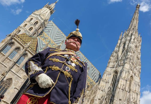 Pensioner Michael Fohler poses with a traditional Husar uniform of regiment #11, as he attends the 330th anniversary celebrations of Habsburg traditional military Hoch und Deutschmeister outside of Saint Stephen’s cathedral on June 18, 2026 in Vienna, Austria. The "Hoch- und Deutschmeister" (K.u.K. Infanterie-Regiment Nr. 4) was one of the most prestigious and famous traditional military units of the Habsburg Empire, with origins dating back to 1696. (Photo by Joe Klamar / AFP)