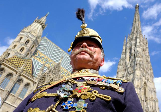 Pensioner Michael Fohler, wears a traditional Husar uniform of regiment #11, as he attends the 330th anniversary celebrations of Habsburg traditional military Hoch und Deutschmeister outside of Saint Stephen’s cathedral on June 18, 2026 in Vienna, Austria. The "Hoch- und Deutschmeister" (K.u.K. Infanterie-Regiment Nr. 4) was one of the most prestigious and famous traditional military units of the Habsburg Empire, with origins dating back to 1696. (Photo by Joe Klamar / AFP)