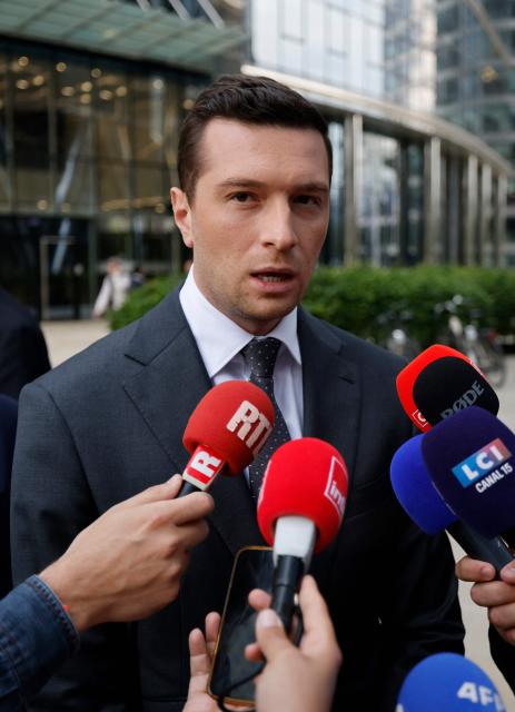 Jordan Bardella, French far-right Rassemblement National (RN) party's President, member of the European Parliament and president of the Patriots for Europe (PfE) group speaks to journalists in front of the Frontex, the European Border and Coast Guard Agency building in Warsaw, Poland on June 18, 2026. Jordan Bardella is in Warsaw to meet with leaders of Polands far right, marking the latest stop on his overseas tour aimed at strengthening his European alliances just a few months before the French presidential election. (Photo by Wojtek RADWANSKI / AFP)
