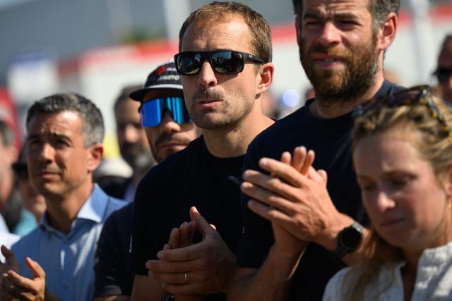British skipper Sam Goodchild pays tribute to late French skipper Charlie Dalin, before the podium ceremony of the race, in Les Sables-d'Olonne on June 18, 2026. French offshore sailor and Vendee Globe 2024/2025 winner Charlie Dalin has died in Quimper, western France, aged 42, from cancer, his family announced on June 11, 2026. (Photo by Loic VENANCE / AFP)