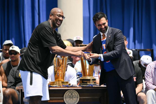 New York City Mayor Zohran Mamdani (R) gives New York Knicks head coach Mike Brown the Keys of the City during a championship celebration and Key to the City ceremony at City Hall Plaza after a ticker-tape parade honoring the team's NBA Finals victory in New York City on June 18, 2026. (Photo by ANGELA WEISS / AFP)