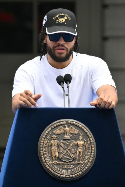 New York Knicks' #11 Jalen Brunson speaks during a championship celebration and Key to the City ceremony at City Hall Plaza after a ticker-tape parade honoring the team's NBA Finals victory in New York City on June 18, 2026. (Photo by ANGELA WEISS / AFP)