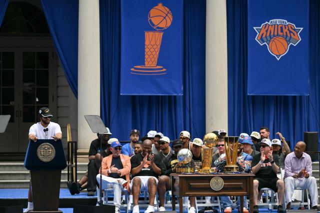 New York Knicks' #11 Jalen Brunson (L) speaks during a championship celebration and Key to the City ceremony at City Hall Plaza after a ticker-tape parade honoring the team's NBA Finals victory in New York City on June 18, 2026. (Photo by ANGELA WEISS / AFP)