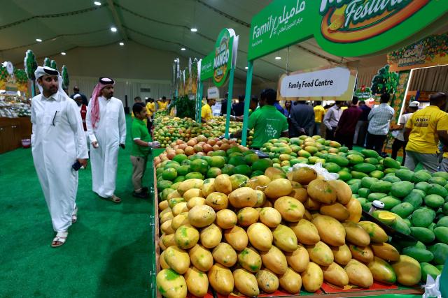 Visitors attend the 3rd edition of the Indian Mango Festival (Hamba Exhibition) at Souq Waqif in Doha on June 18, 2026. (Photo by Karim JAAFAR / AFP)