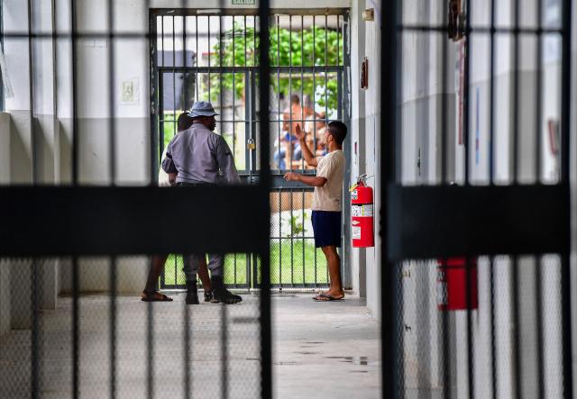 (FILES) Young inmates talk to a guard at Pacora Detention Center, in the outskirts of Panama City on November 22, 2018. Panama's President Jose Raul Mulino announced on June 18, 2026 plans to harden the country’s prison system after nearly 200 inmates escaped in early June, most of whom have since been recaptured. (Photo by Luis ACOSTA / AFP)