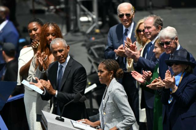 Former US First Lady Michelle Obama speaks at the opening of the Barack Obama Presidential Center in Chicago, Illinois, on June 18, 2026, applauded by, L to R, front row, Sasha Obama, Malia Obama, former US president Barack Obama, back row, former US president Joe Biden, his wife Jill Biden, former US president George W. Bush, his wife Laura Bush, former US president Bill Clinton and his wife Hillary Clinton. (Photo by Pedro UGARTE / AFP)