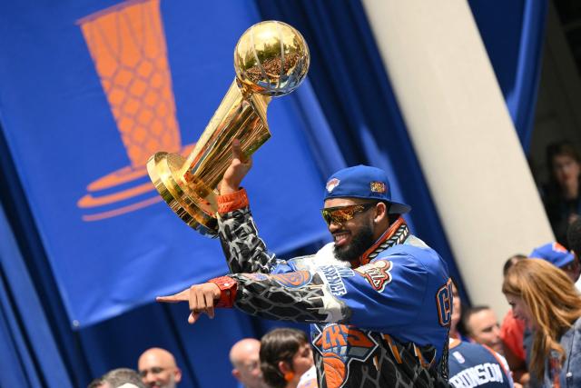 Karl-Anthony Towns #32 of the New York Knicks holds the Larry O'Brien Championship Trophy during a championship celebration and Key to the City ceremony at City Hall Plaza after a ticker-tape parade honoring the team's NBA Finals victory in New York City on June 18, 2026. (Photo by ANGELA WEISS / AFP)