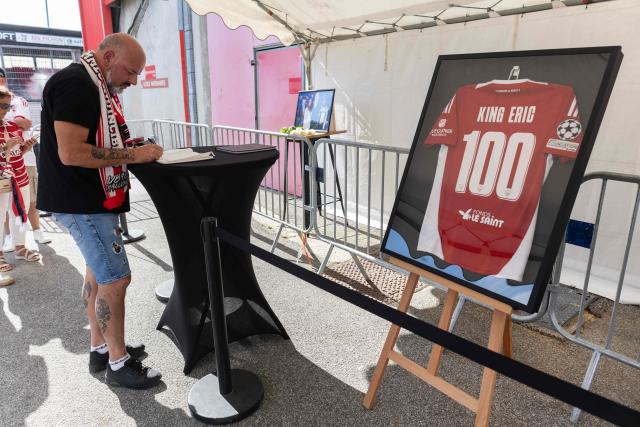 An attendee signs a log book at the entrance of the Francis-Le Ble stadium in Brest, western France on June 18, 2026 to pay tribute to the late Stade Brestois coach Eric Roy who died on day prior. Brest coach Eric Roy, 58, has died from pancreatic cancer on June 17, his family announced on via the late manager’s Instagram account. (Photo by Fred TANNEAU / AFP)