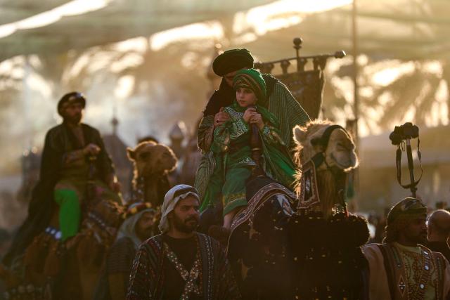 Shiite mourners take part in the Al-Haidariyah Public Procession reenacting the arrival of Imam Hussein, his family and companions in the Iraqi holy city of Karbala on the second day of Muharram, during commemorations marking Ashura on June 18, 2026. Ashura is one of the most important commemorations for Shiite Muslims, and falls on the 10th day of Muharram, which is the mourning period for the seventh-century killing of Imam Hussein, the grandson of the Prophet Muhammad. (Photo by Karar Jabbar / AFP)
