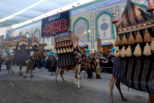 Shiite mourners take part in the Al-Haidariyah Public Procession reenacting the arrival of Imam Hussein, his family and companions in the Iraqi holy city of Karbala on the second day of Muharram, during commemorations marking Ashura on June 18, 2026. Ashura is one of the most important commemorations for Shiite Muslims, and falls on the 10th day of Muharram, which is the mourning period for the seventh-century killing of Imam Hussein, the grandson of the Prophet Muhammad. (Photo by Karar Jabbar / AFP)