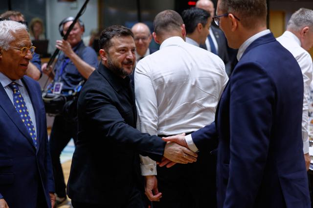 Ukraine's President Volodymyr Zelensky shakes hands with Finland's Prime Minister Petteri Orpo as they attend a round table meeting of EU leaders and Ukraine during the EU Summit at the EU headquarters in Brussels, on June 18, 2026. (Photo by Geert Vanden Wijngaert / POOL / AFP)