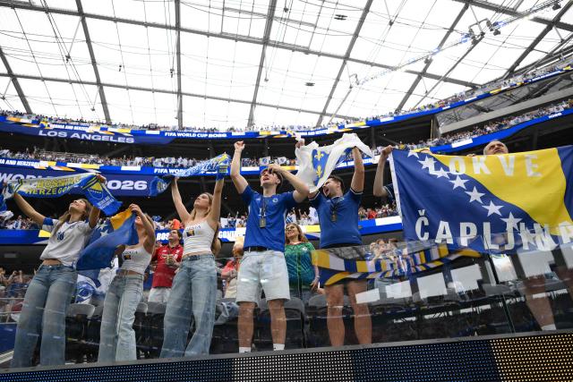 Bosnian fans cheer for their team ahead of the 2026 World Cup Group B football match between Switzerland and Bosnia and Herzegovina at Los Angeles Stadium in Inglewood on June 18, 2026.  (Photo by Patrick T. Fallon / AFP)