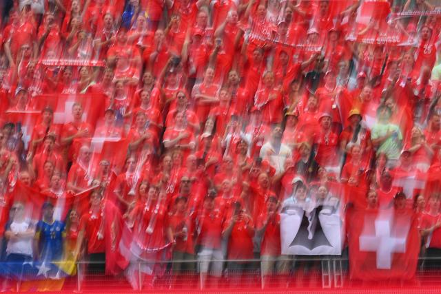 This slow shutter photograph show Swiss fans cheering for their team ahead of the 2026 World Cup Group B football match between Switzerland and Bosnia and Herzegovina at Los Angeles Stadium in Inglewood on June 18, 2026.  (Photo by Patrick T. Fallon / AFP)