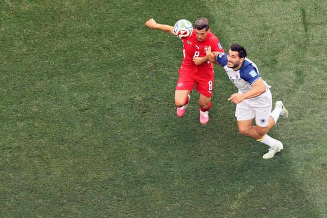 Switzerland's midfielder #08 Remo Freuler and Bosnia-Herzegovina's defender #05 Sead Kolasinac fight for the ball during the 2026 World Cup Group B football match between Switzerland and Bosnia and Herzegovina at Los Angeles Stadium in Inglewood on June 18, 2026.  (Photo by Etienne Laurent / AFP)