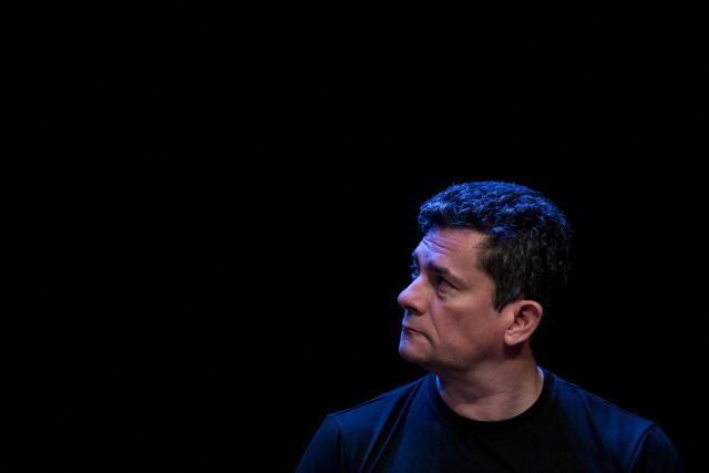 Senator Sergio Moro looks on as Brazilian Senator and presidential hopeful Flavio Bolsonaro presents a proposal to combat criminal organizations during an event in Sao Paulo, Brazil, on June 18, 2026. (Photo by Nelson ALMEIDA / AFP)