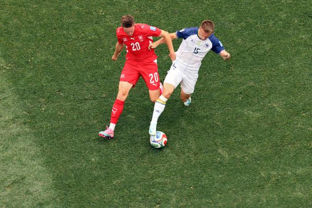 Switzerland's midfielder #20 Michel Aebischer and Bosnia-Herzegovina's forward #15 Amar Memic fight for the ball during the 2026 World Cup Group B football match between Switzerland and Bosnia and Herzegovina at Los Angeles Stadium in Inglewood on June 18, 2026.  (Photo by Etienne Laurent / AFP)