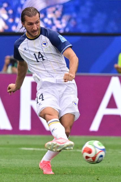 Bosnia-Herzegovina's midfielder #14 Ivan Sunjic kicks the ball during the 2026 World Cup Group B football match between Switzerland and Bosnia and Herzegovina at Los Angeles Stadium in Inglewood on June 18, 2026.  (Photo by Frederic J. Brown / AFP)