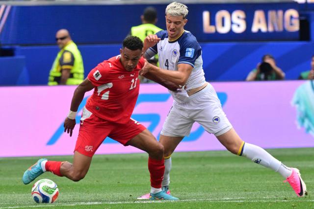 Switzerland's forward #11 Dan Ndoye and Bosnia-Herzegovina's defender #04 Tarik Muharemovic fight for the ball during the 2026 World Cup Group B football match between Switzerland and Bosnia and Herzegovina at Los Angeles Stadium in Inglewood on June 18, 2026.  (Photo by Frederic J. Brown / AFP)