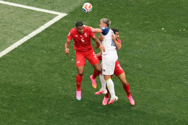 (L-R) Switzerland's defender #05 Manuel Akanji, Bosnia-Herzegovina's forward #10 Ermedin Demirovic, and Switzerland's defender #13 Ricardo Rodriguez fight for the ball during the 2026 World Cup Group B football match between Switzerland and Bosnia and Herzegovina at Los Angeles Stadium in Inglewood on June 18, 2026.  (Photo by Etienne Laurent / AFP)
