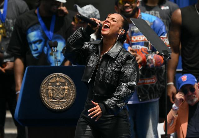Members of the New York Knicks stand on stage as US singer-songwriter Alicia Keys performs during a championship celebration and Key to the City ceremony at City Hall Plaza after a ticker-tape parade honoring the team's NBA Finals victory in New York City on June 18, 2026. (Photo by ANGELA WEISS / AFP)