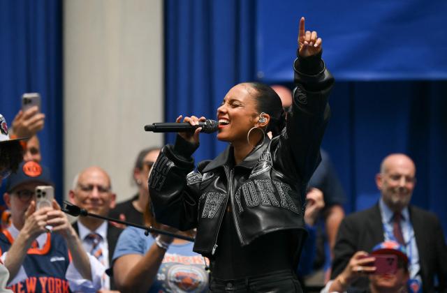 Members of the New York Knicks stand on stage as US singer-songwriter Alicia Keys performs during a championship celebration and Key to the City ceremony at City Hall Plaza after a ticker-tape parade honoring the team's NBA Finals victory in New York City on June 18, 2026. (Photo by ANGELA WEISS / AFP)