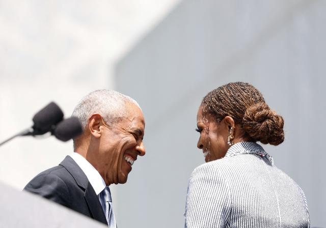 Former president Barack Obama and his wife Michelle Obama smile at each other during the opening of the Barack Obama Presidential Center in Chicago, Illinois, on June 18, 2026. (Photo by Kamil Krzaczynski / AFP)