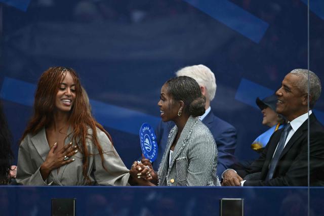 Former president Barack Obama, his wife Michelle Obama and their daughter Malia Obama attend the opening of the Barack Obama Presidential Center in Chicago, Illinois, on June 18, 2026. (Photo by Kent NISHIMURA / AFP)