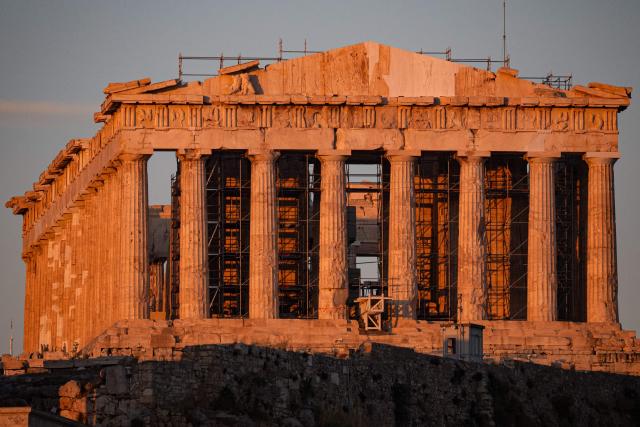 This photograph shows the ancient Parthenon temple atop the Acropolis, free of external scaffolding after renovation work, in Athens on June 18, 2026. Greece's culture ministry on June 18, 2026 said it had finished a lengthy restoration, after 220 years, of the western facade of the Parthenon in Athens, re-creating the world-famous monument's early 1800s look. The 2,500-year-old temple honouring the goddess Athena, which sits on a hill overlooking the Greek capital, is visited by more than four million people each year. (Photo by Angelos TZORTZINIS / AFP)