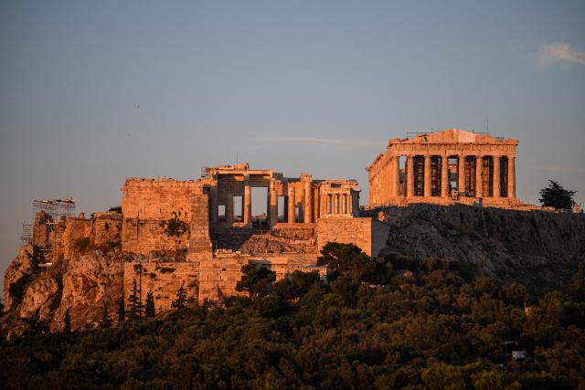 This photograph shows the ancient Parthenon temple atop the Acropolis, free of external scaffolding after renovation work, in Athens on June 18, 2026. Greece's culture ministry on June 18, 2026 said it had finished a lengthy restoration, after 220 years, of the western facade of the Parthenon in Athens, re-creating the world-famous monument's early 1800s look. The 2,500-year-old temple honouring the goddess Athena, which sits on a hill overlooking the Greek capital, is visited by more than four million people each year. (Photo by Angelos TZORTZINIS / AFP)