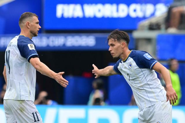 Bosnia-Herzegovina's forward #11 Edin Dzeko and defender #07 Amar Dedic shake hands during the 2026 World Cup Group B football match between Switzerland and Bosnia and Herzegovina at Los Angeles Stadium in Inglewood on June 18, 2026.  (Photo by Frederic J. Brown / AFP)