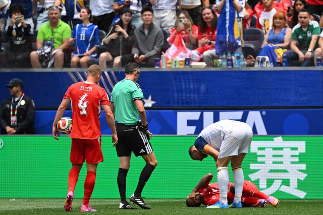 Bosnia-Herzegovina's forward #11 Edin Dzeko checks Switzerland's defender #05 Manuel Akanji as he lies on the ground during the 2026 World Cup Group B football match between Switzerland and Bosnia and Herzegovina at Los Angeles Stadium in Inglewood on June 18, 2026.  (Photo by Patrick T. Fallon / AFP)