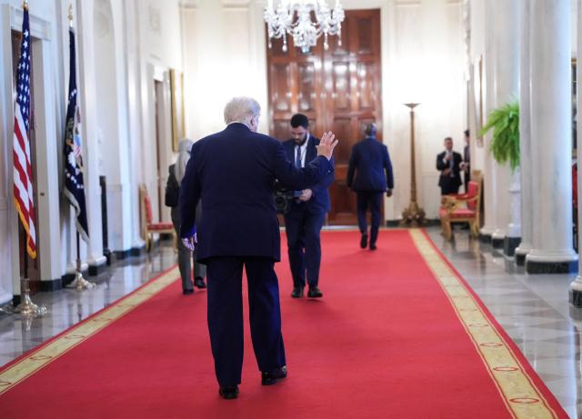 US President Donald Trump waves as he walks through the Cross Hall after participating in a Medal of Honor ceremony in the East Room of the White House in Washington, DC on June 18, 2026. (Photo by Ken Cedeno / AFP)