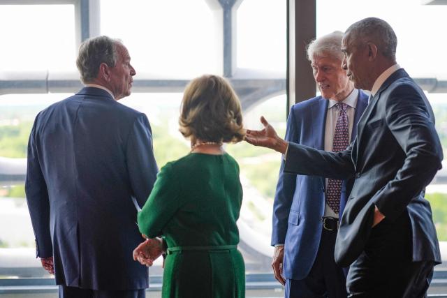 Former President Barack Obama, gestures to former President George W. Bush, as former first lady Laura Bush and former President Bill Clinton watch, ahead of the dedication ceremony at the Obama Presidential Center on June 18, 2026, in Chicago. (Photo by Pablo Martinez Monsivais / POOL / AFP)