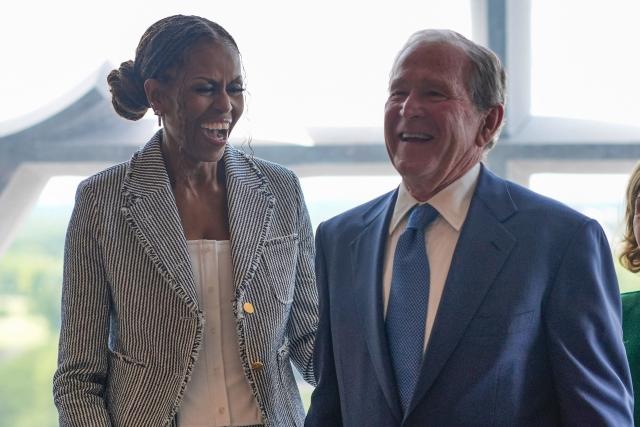 Former President George W. Bush laughs with former first lady Michelle Obama ahead of the dedication ceremony at the Obama Presidential Center on June 18, 2026, in Chicago. (Photo by Pablo Martinez Monsivais / POOL / AFP)