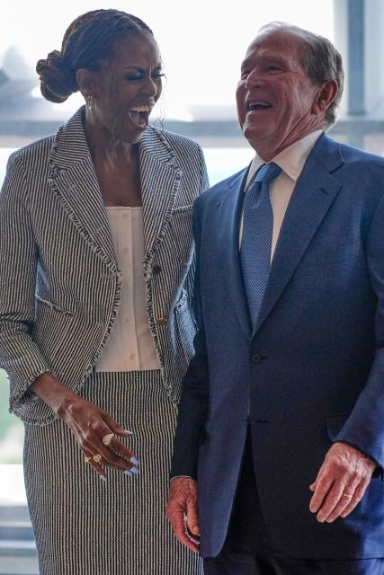 Former President George W. Bush laughs with former first lady Michelle Obama ahead of the dedication ceremony at the Obama Presidential Center on June 18, 2026, in Chicago. (Photo by Pablo Martinez Monsivais / POOL / AFP)