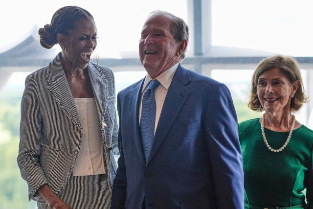 Former President George W. Bush laughs with former first lady Michelle Obama as former first lady Laura Bush smiles, ahead of the dedication ceremony at the Obama Presidential Center on June 18, 2026, in Chicago. (Photo by Pablo Martinez Monsivais / POOL / AFP)