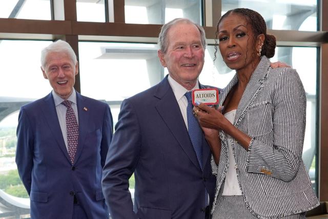 Former President Bill Clinton smiles as former President George W. Bush gives former first lady Michelle Obama mints ahead of the dedication ceremony at the Obama Presidential Center on June 18, 2026, in Chicago. (Photo by Pablo Martinez Monsivais / POOL / AFP)