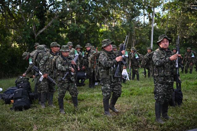 Members of the Coordinadora Nacional Ejercito Bolivariano (CNEB) guerrilla group take part in a disarmament ceremony agreed with the Colombian government in the municipality of Valle del Guamuez, Putumayo department, Colombia on June 18, 2026. (Photo by Raul ARBOLEDA / AFP)