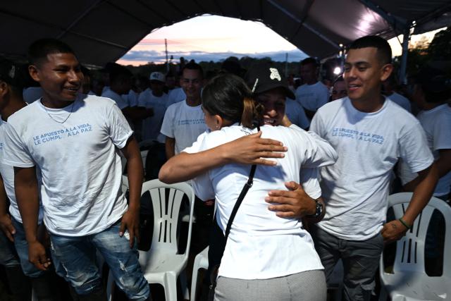 Members of the Coordinadora Nacional Ejercito Bolivariano (CNEB) guerrilla group take part in a disarmament ceremony agreed with the Colombian government in the municipality of Valle del Guamuez, Putumayo department, Colombia on June 18, 2026. Three days before a runoff vote set to determine the continuation of the country's first leftist government, this marks a first step for the rebels to settle in a special zone where they aim to consolidate agreements with the government. (Photo by Raul ARBOLEDA / AFP)