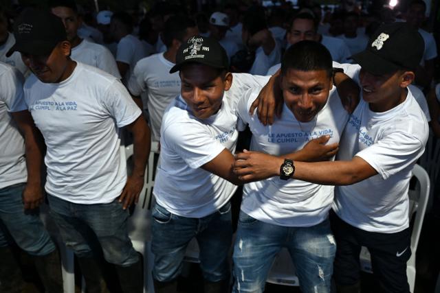 Members of the Coordinadora Nacional Ejercito Bolivariano (CNEB) guerrilla group take part in a disarmament ceremony agreed with the Colombian government in the municipality of Valle del Guamuez, Putumayo department, Colombia on June 18, 2026. Three days before a runoff vote set to determine the continuation of the country's first leftist government, this marks a first step for the rebels to settle in a special zone where they aim to consolidate agreements with the government. (Photo by Raul ARBOLEDA / AFP)