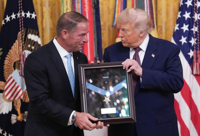 US President Donald Trump awards the Medal of Honor posthumously to US Marine Corps Colonel John W. Ripley, for his actions in 1972 during the Battle of Dong Ha, as his son Tom Ripley accepts the award on his behalf, during a ceremony in the East Room of the White House in Washington, DC, on June 18, 2026. (Photo by Ken Cedeno / AFP)