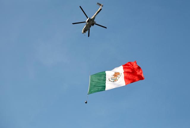 A helicopter carring a Mexican flag flies over the stadium ahead of the 2026 World Cup Group A football match between Mexico and South Korea at the Guadalajara Stadium in Zapopan on June 18, 2026.  (Photo by ULISES RUIZ / AFP)