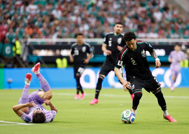 South Korea's midfielder #10 Lee Jae-sung falls next to Mexico's defender #02 Jorge Sanchez during the 2026 World Cup Group A football match between Mexico and South Korea at the Guadalajara Stadium in Zapopan on June 18, 2026.  (Photo by Ulises RUIZ / AFP)