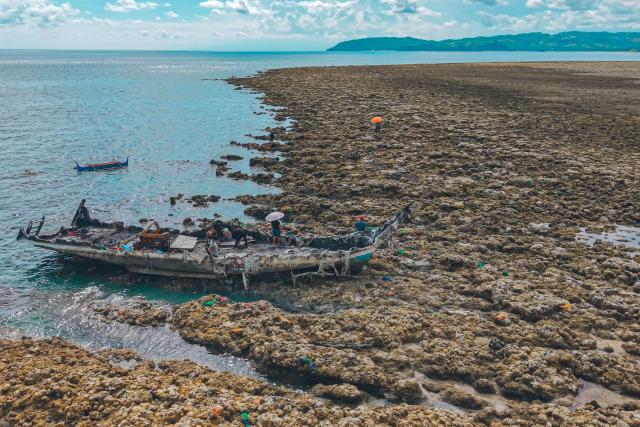This photo taken on June 18, 2026, shows an aerial photo of the coastal uplift following an earthquake along the Pangyan Marine Sanctuary in Glan, Sarangani. A powerful earthquake that killed at least 61 people in the Philippines raised the seabed by as much as two metres (6.6 feet), exposing coral and harming marine life, the environment department said on June 14. (Photo by Ferdinandh Cabrera / AFP)