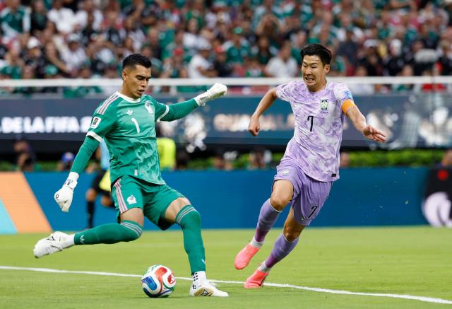 Mexico's goalkeeper #01 Raul Rangel and South Korea's forward #07 Son Heung-min fight for the ball during the 2026 World Cup Group A football match between Mexico and South Korea at the Guadalajara Stadium in Zapopan on June 18, 2026.  (Photo by Ulises RUIZ / AFP)