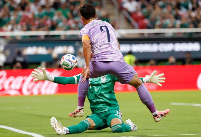 Mexico's goalkeeper #01 Raul Rangel and South Korea's forward #07 Son Heung-min fight for the ball during the 2026 World Cup Group A football match between Mexico and South Korea at the Guadalajara Stadium in Zapopan on June 18, 2026.  (Photo by Ulises RUIZ / AFP)