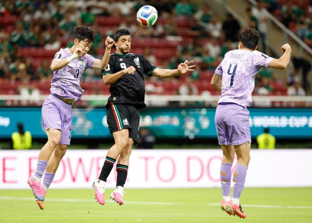 South Korea's defender #03 Lee Gi-hyuk and Mexico's forward #09 Raul Jimenez fight for the ball next to South Korea's defender #04 Kim Min-jae during the 2026 World Cup Group A football match between Mexico and South Korea at the Guadalajara Stadium in Zapopan on June 18, 2026.  (Photo by Ulises RUIZ / AFP)