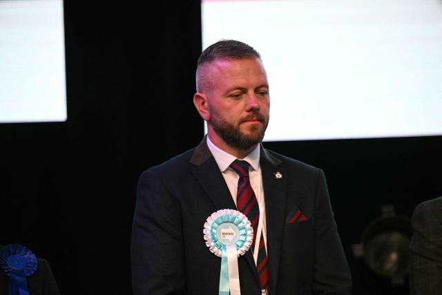 Reform candidate Robert Kenyon is seen after Labour candidate Andy Burnham wins the election for MP of Makerfield, at the count centre venue, the Edge in Wigan, northwest England on June 18, 2026. (Photo by Oli SCARFF / AFP)