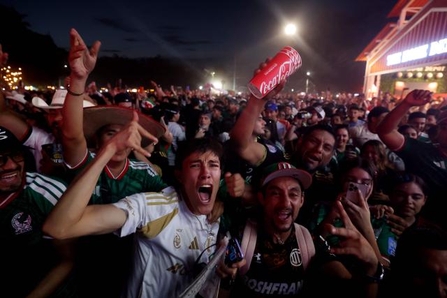 Mexican fans celebrate as they watch the 2026 World Cup football match between Mexico and South Korea on a screen at the Fan Fest in Monterrey, Mexico, on June 18, 2026. (Photo by Julio Cesar AGUILAR / AFP)